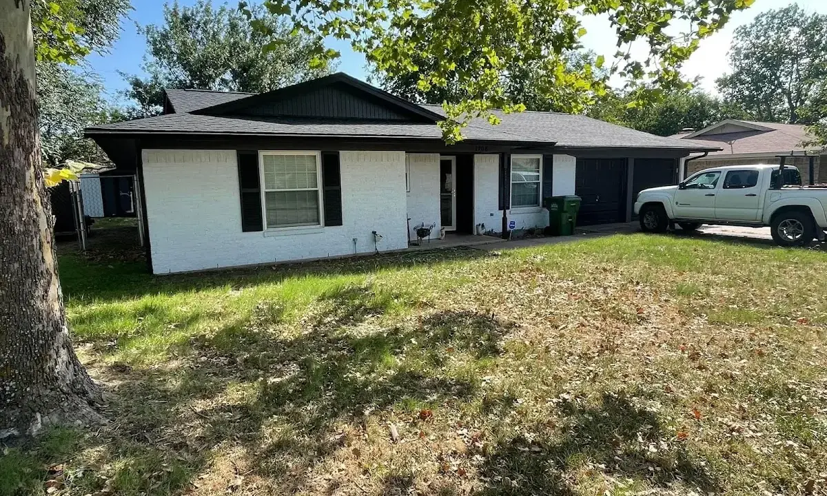 Professional roofing crew working on a residential roof in Gilford